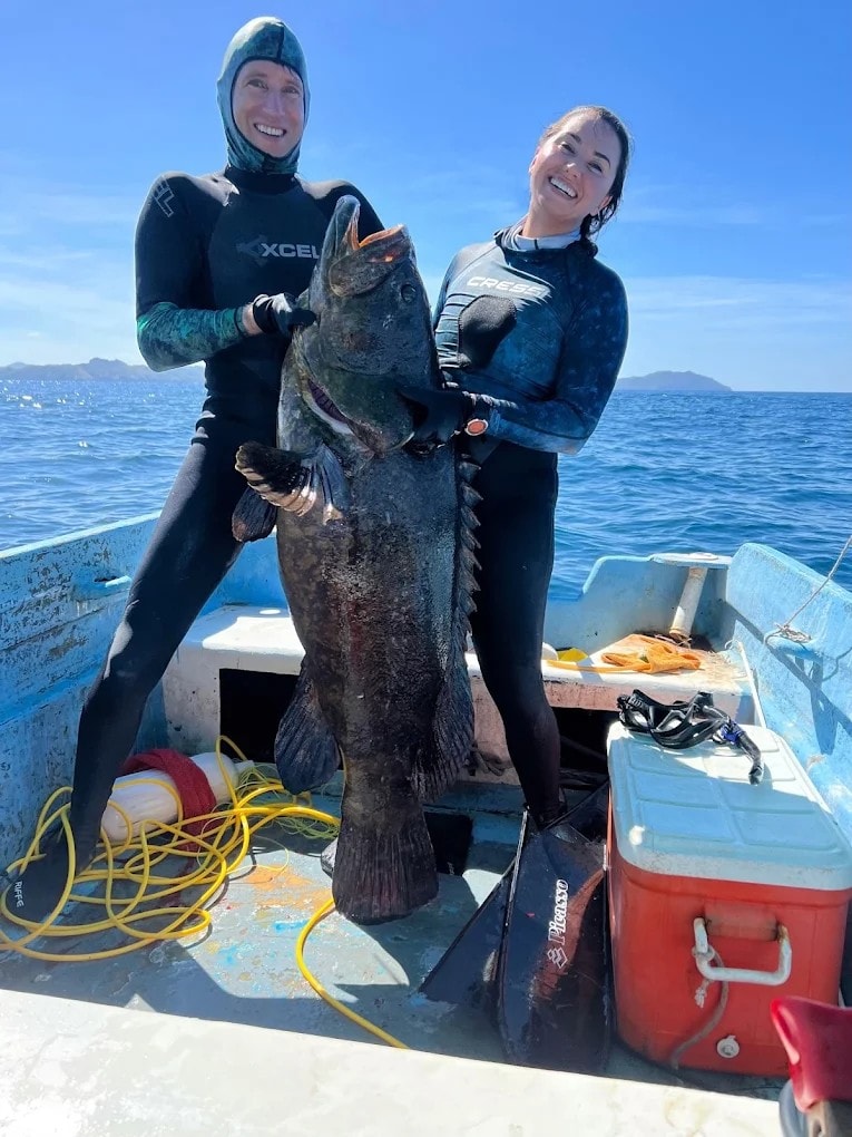 Two guests with a massive grouper on Galo's boat